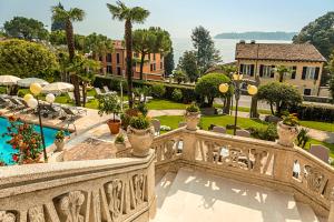 a view from the balcony of a house with a pool at Hotel Laurin in Salò