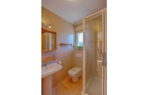 a bathroom with a toilet and a sink and a shower at Villas Guzman - Chirla in Calpe +9 photos