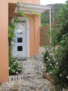 a front door of a house with a stone walkway at Muses Studios Sami in Sami