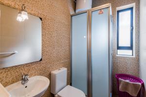 a bathroom with a sink and a toilet and a mirror at Blue Harbour 2 bedroom Seafront Apartments with stunning seaviews - by Getawaysmalta in St. Paul's Bay