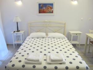 a bedroom with a bed with two pillows on it at Muses Studios Sami in Sami