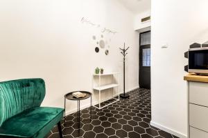 a living room with a couch and a table at BpR Emerald City Apartment in Budapest