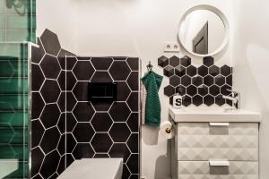 a bathroom with a sink and a mirror at BpR Emerald City Apartment in Budapest +26 photos