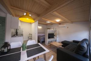 a living room with a couch and a table at atico patio de la plata in Toledo +6 photos