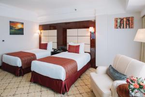 Postel nebo postele na pokoji v ubytování Golden Tulip Addis Ababa