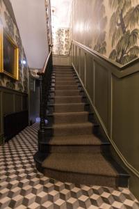 a staircase in a building with a checkered floor at Georgian House Hotel in London