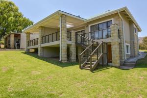 a house with a large yard in front of it at Willow Rest Villas in Clarens