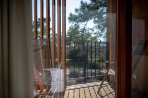 an open door to a balcony with a fence at Pestana Troia Eco-Resort & Residences in Troia