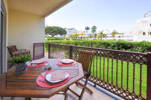 a wooden table on the balcony of a house at Bogart at Casablanca by OCvillas in Albufeira