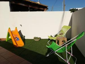 a patio with two chairs and a slide at Casammare in Marina di Modica