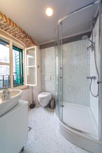 a bathroom with a shower and a sink and a toilet at Luxury San Giovanni Apartment 1 in Split