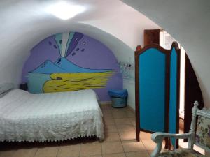 um quarto com uma cama e um quadro na parede em La Casetta em Nápoles