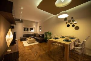 a living room with a table and a couch at Apartment NS Life in Novi Sad