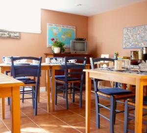 a dining room with tables and chairs and a tv at B&B La Bedondaine in Quebec City