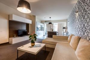 a living room with a couch and a table at Orhideea Residence & Spa in Bucharest