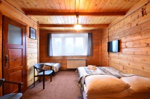 a bedroom with two beds in a wooden room at DOM WYPOCZYNKOWY ŻAK in Białka Tatrzańska