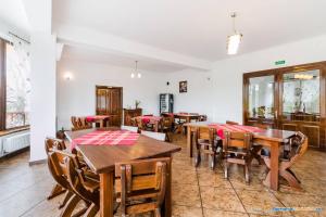 a dining room with wooden tables and chairs at Pension Creasta de Vis in Fundata