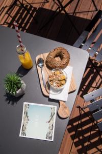 a table with a bowl of food and a funnel cake at The Modernist Thessaloniki in Thessaloniki