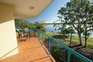 a balcony of a house with a view of the water at The Esplanade Riverview Holiday Apartments in Maroochydore