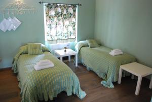 a room with two beds and a table and a window at Stella in Terlizzi