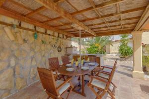 a wooden table and chairs on a patio at Villas Guzman - Kismet in Moraira