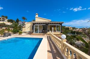 a villa with a swimming pool and a house at Villas Guzman - Kismet in Moraira