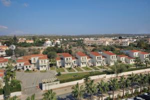 an aerial view of a city with houses and palm trees at Nissiana Hotel & Bungalows in Ayia Napa