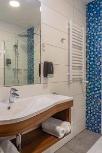 a bathroom with a sink and a shower at Hotel Topaz Poznań Centrum in Poznań