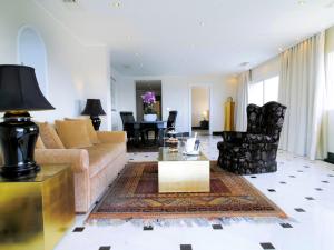a living room with a couch and a table at Out Of The Blue Resort & Spa in Agia Pelagia