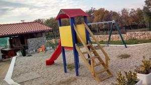 a playground with a slide and a ladder at Apartments Gorančica in Malinska