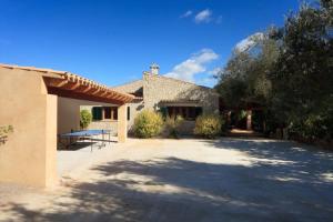 a house with a large driveway in front of it at Can Venzala in Pollença
