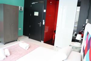 a bathroom with a white bed and a red wall at Hotel Freedom in Madrid +45 photos