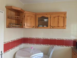 a kitchen with a table and red and white tiles at Villa dhiefa avec piscine in Temlale