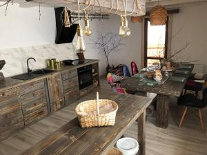 a kitchen with wooden cabinets and a table with a basket at ГУЦУЛЬСЬКА ХАТА in Yasinya
