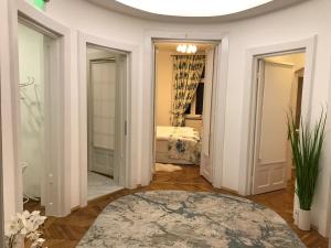 a room with a bedroom with a bed and a mirror at VICTORIA LUXURY APARTMENT in Bucharest