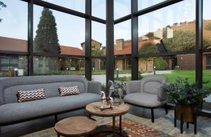 a large room with a couch and a table and chairs at Merom Golan Resort in Merom Golan