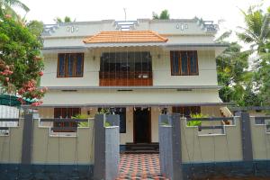 a building with a gate in front of it at JEEVAN HOMESTAY kovalam in Kovalam