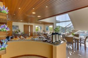 a dining room with a table and chairs in a building at Pousada Ilha Faceira in Florianópolis