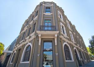 a large brick building with a large window at Vulcan Hotel Sydney in Sydney