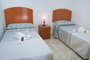 Postel nebo postele na pokoji v ubytování Hostal Batato