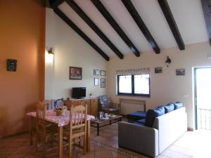 a living room with a table and a couch at Casa Benito in Ribadeo