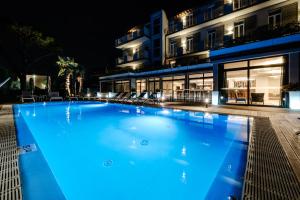 a large swimming pool in front of a building at night at Hotel Palazzo del Garda & Spa in Desenzano del Garda