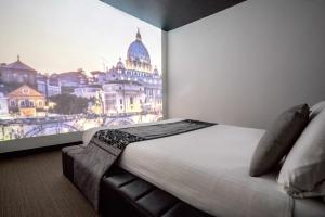 a bedroom with a large picture of a building at iRooms Campo dei Fiori in Rome