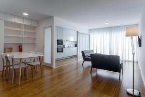 a kitchen and dining room with a table and chairs at Market Place in Ponta Delgada