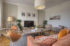 a living room with a couch and a table at Santa Apolonia 7D - 6 Bedrooms in Lisbon