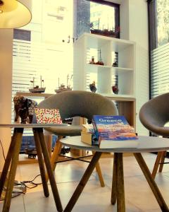 a table with a chair and books on it at Spot Apart in Athens