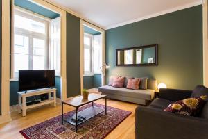 a living room with a couch and a tv at Glória by Central Hill Apartments in Lisbon