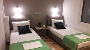 A bed or beds in a room at Phaedra Apartment