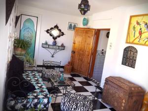 a living room with a couch and a checkerboard floor at Riad Atika Mek in Meknès