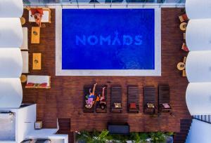 a large sign on the side of a building at Nomads Hotel & Rooftop Pool Cancun in Cancún